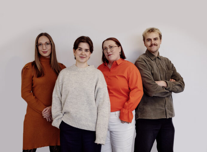 Group image of the team members standing in front of a white backdrop